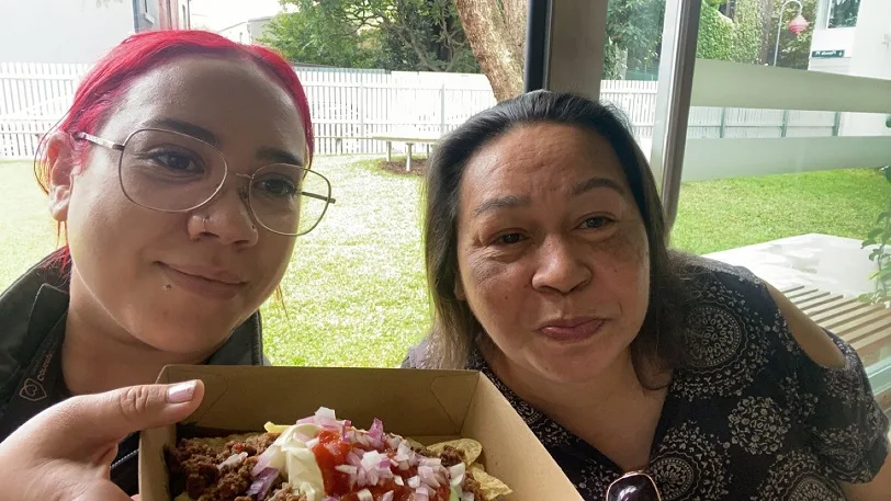 Home Care Services Client and support worker of Concept Care eating pizza together